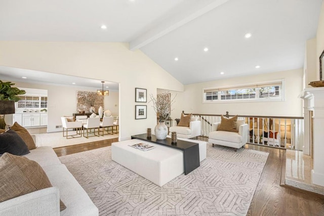 living room with hardwood / wood-style floors, high vaulted ceiling, and beamed ceiling