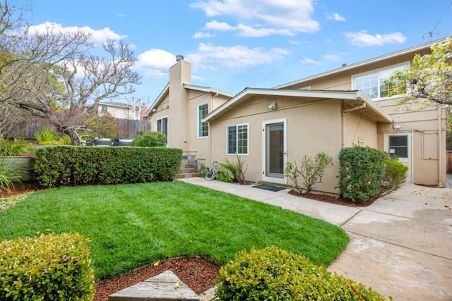 rear view of property featuring a yard