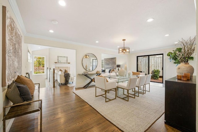 dining room featuring an inviting chandelier, dark hardwood / wood-style floors, and crown molding