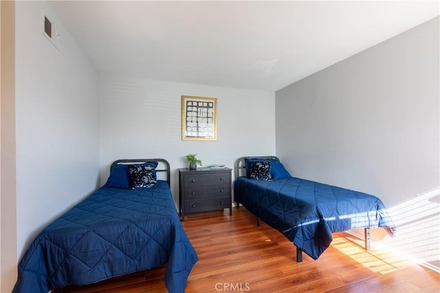 bedroom with hardwood / wood-style floors