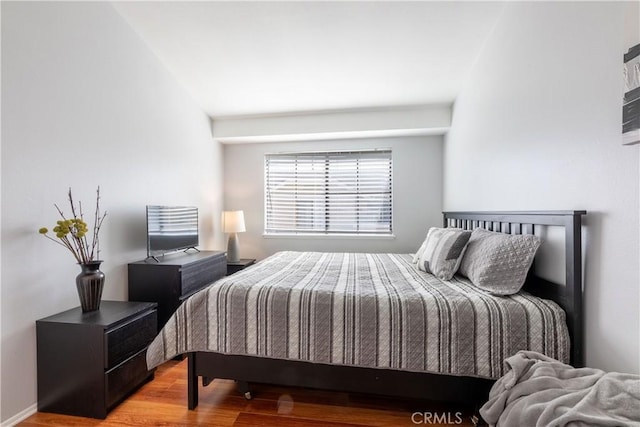 bedroom with wood-type flooring