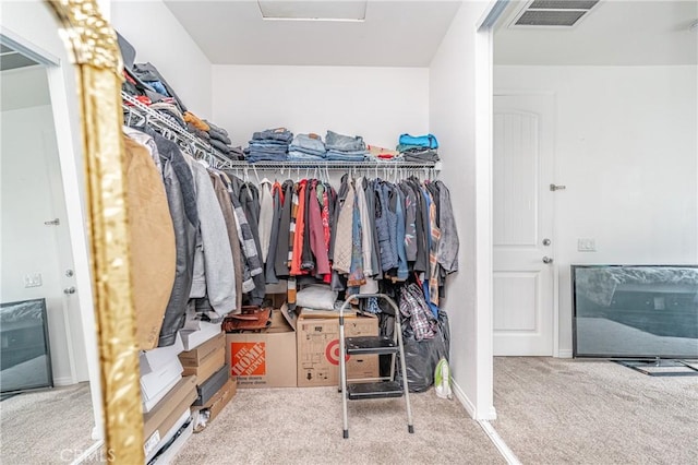 walk in closet featuring carpet