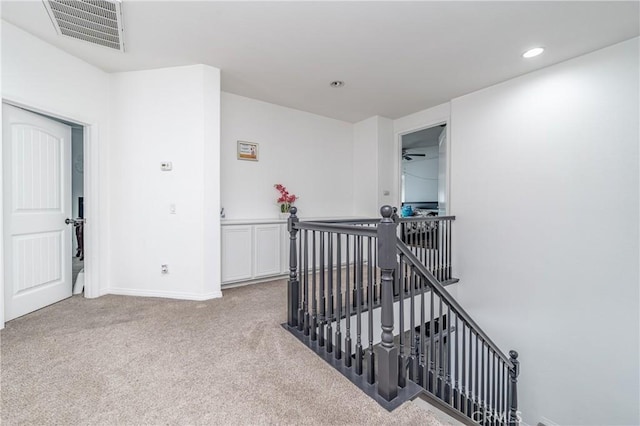 hallway with light colored carpet