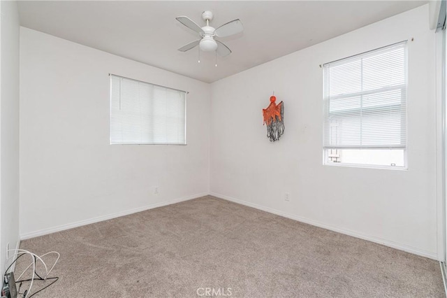 unfurnished room featuring light carpet and ceiling fan