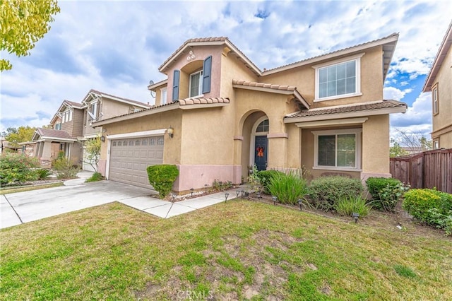 mediterranean / spanish house with a garage and a front yard