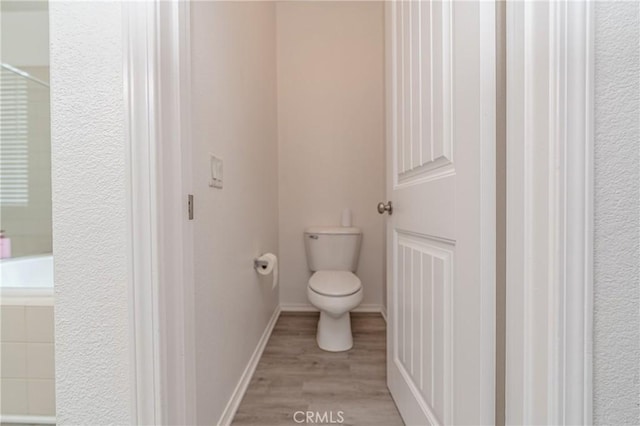 bathroom with wood-type flooring and toilet