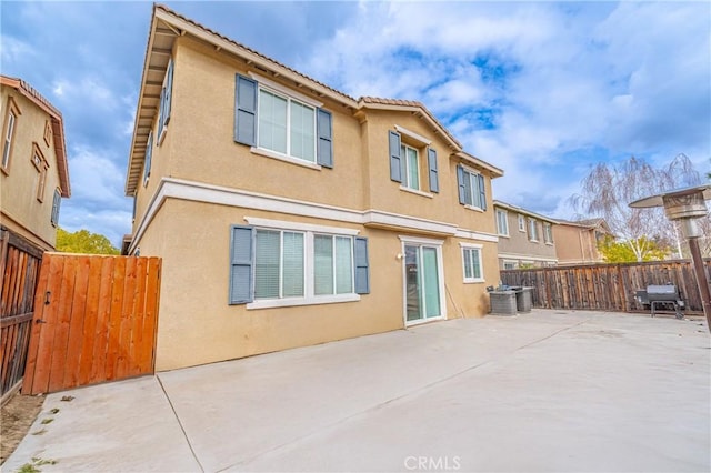 back of property with a patio