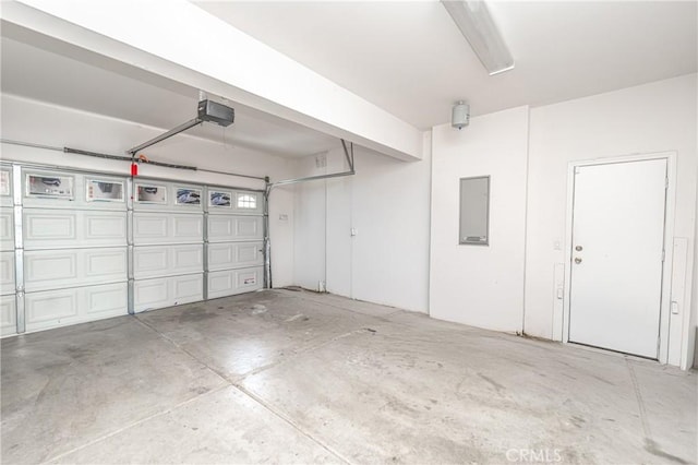 garage featuring a garage door opener and electric panel