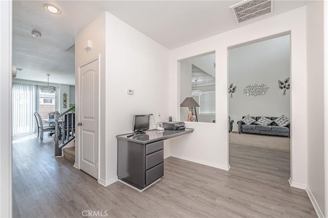 corridor with hardwood / wood-style floors