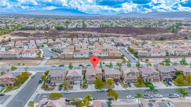 birds eye view of property with a mountain view