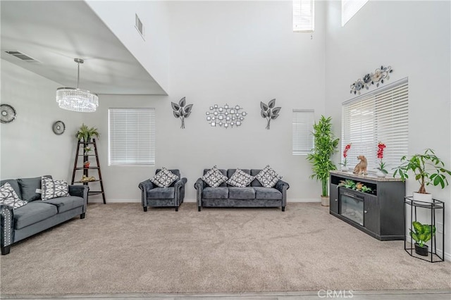 living room featuring a towering ceiling and carpet flooring