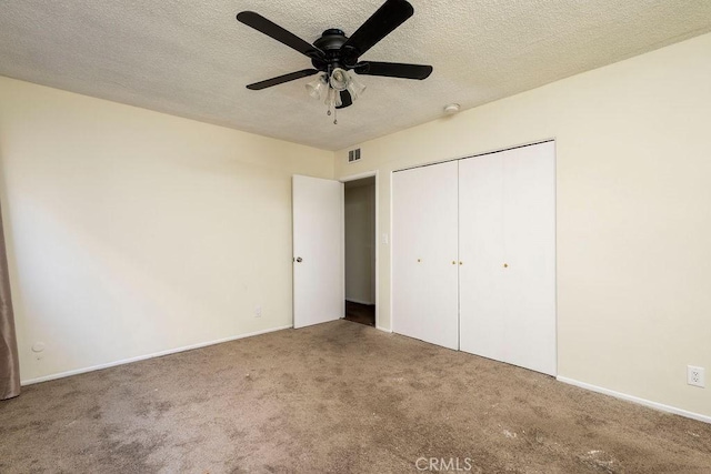 unfurnished bedroom featuring carpet floors, a closet, and ceiling fan