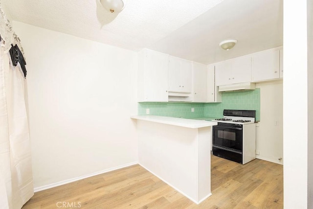 kitchen with range with gas cooktop, white cabinetry, light hardwood / wood-style floors, kitchen peninsula, and a textured ceiling