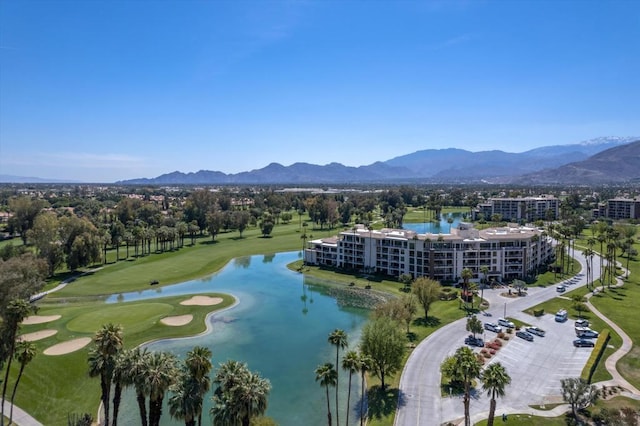 birds eye view of property with a water and mountain view