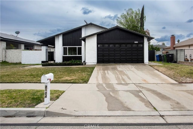 view of front of home with a garage and a front lawn