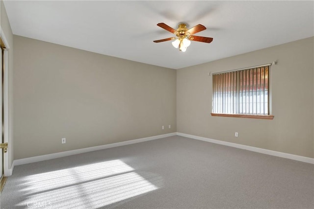 empty room featuring carpet floors and ceiling fan