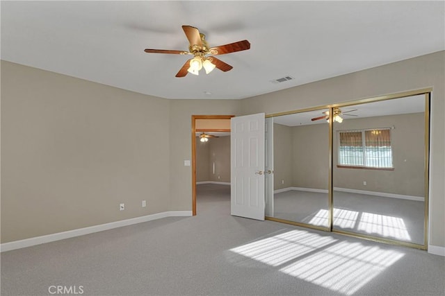 unfurnished bedroom with ceiling fan, carpet, and a closet