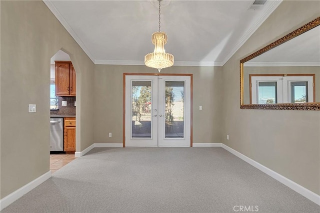 interior space with french doors, light colored carpet, and ornamental molding