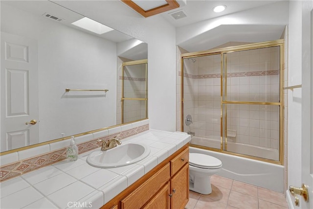 full bathroom with enclosed tub / shower combo, tile patterned floors, toilet, and vanity