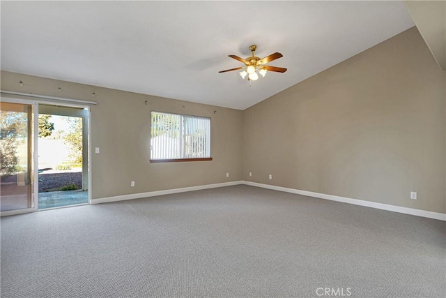 spare room featuring ceiling fan, vaulted ceiling, and carpet