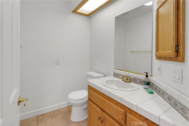 bathroom featuring vanity, tile patterned floors, and toilet