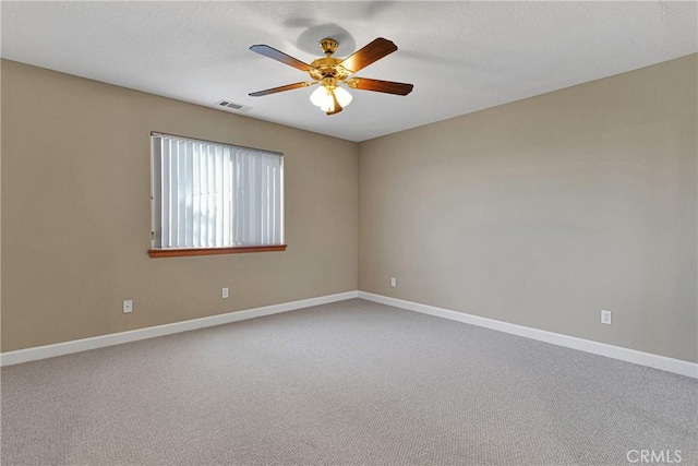 spare room featuring carpet floors and ceiling fan