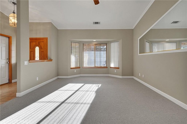 carpeted spare room with crown molding and ceiling fan