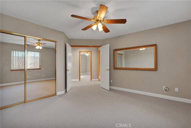 unfurnished bedroom with carpet floors, a closet, and ceiling fan