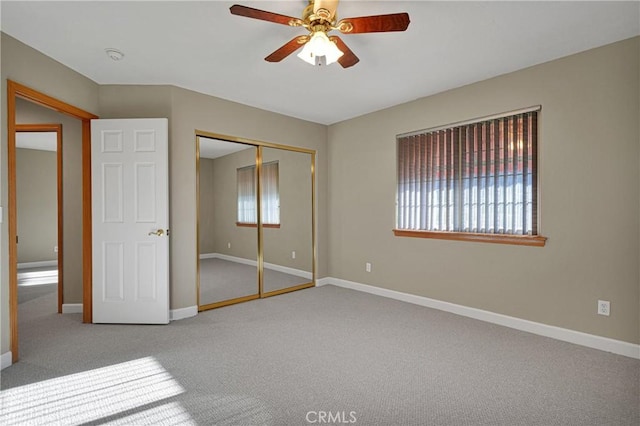 unfurnished bedroom featuring ceiling fan, carpet floors, and a closet