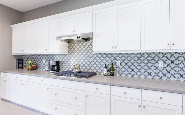 kitchen with stainless steel gas cooktop, decorative backsplash, and white cabinets