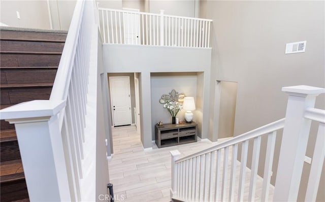 stairway featuring a high ceiling