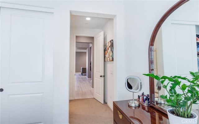 corridor featuring light colored carpet