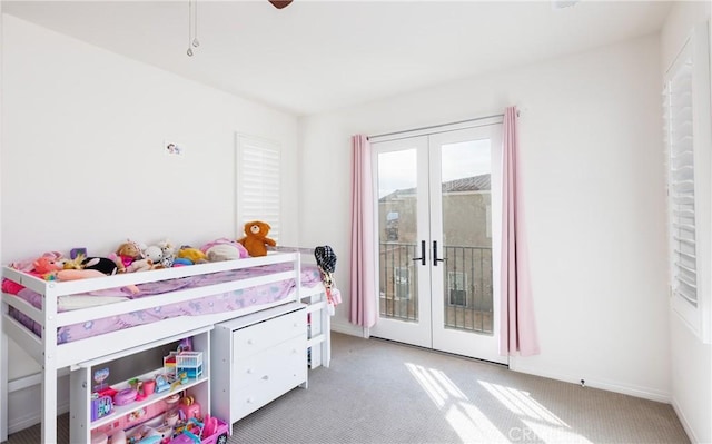 bedroom featuring light carpet, access to outside, french doors, and ceiling fan