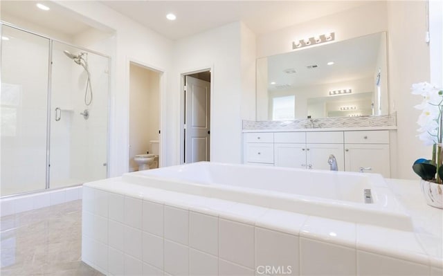 full bathroom with vanity, shower with separate bathtub, and toilet