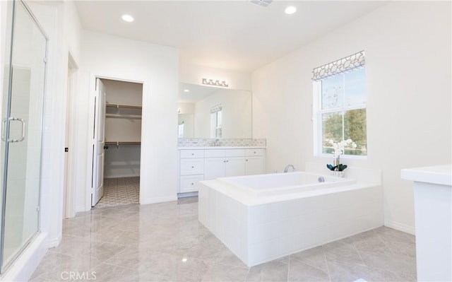 bathroom featuring vanity and plus walk in shower