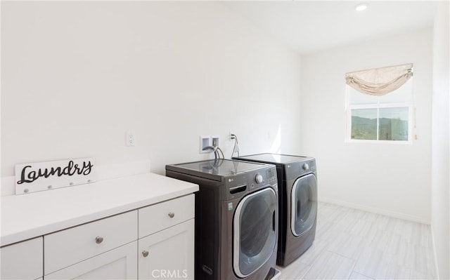 laundry room featuring cabinets and independent washer and dryer