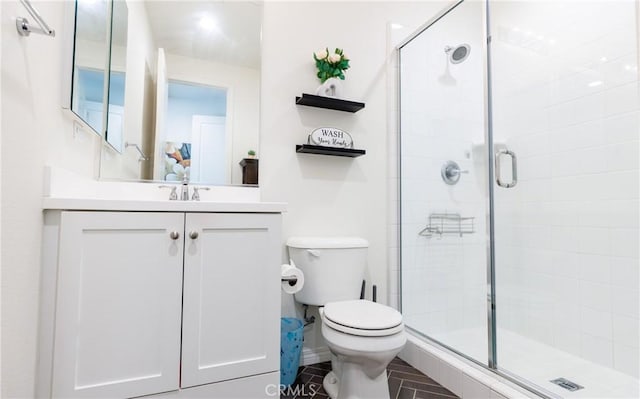 bathroom with vanity, an enclosed shower, and toilet