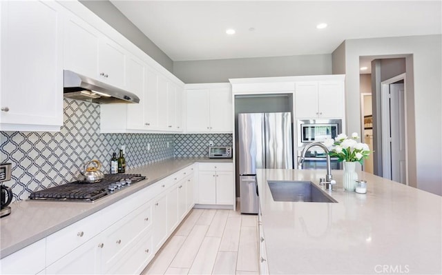 kitchen featuring white cabinetry, appliances with stainless steel finishes, sink, and decorative backsplash