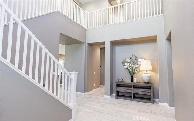 entryway with hardwood / wood-style flooring and a high ceiling