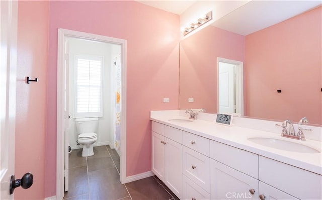 bathroom featuring tile patterned floors, toilet, and vanity