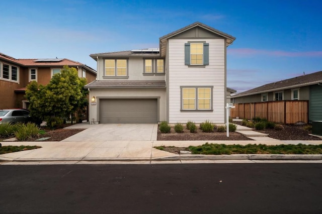 front of property with a garage and solar panels