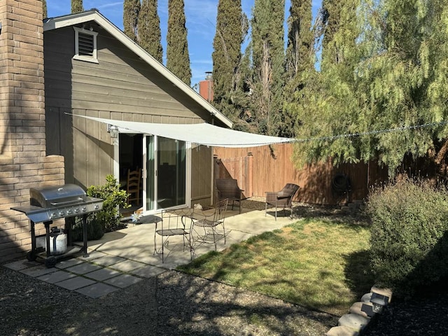 rear view of property featuring a patio and a yard