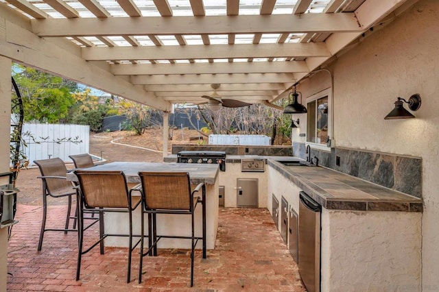 view of patio featuring a grill, an outdoor kitchen, a wet bar, and a pergola