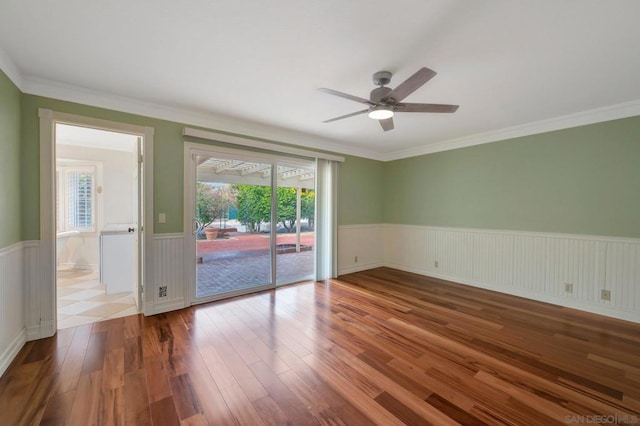 unfurnished room with hardwood / wood-style floors, crown molding, and ceiling fan