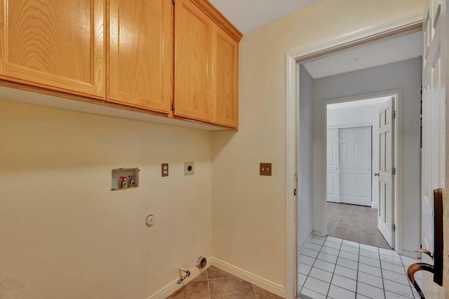 laundry room with light tile patterned flooring, cabinets, hookup for a washing machine, hookup for an electric dryer, and hookup for a gas dryer