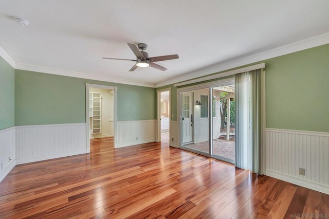 spare room with crown molding, ceiling fan, and light hardwood / wood-style flooring