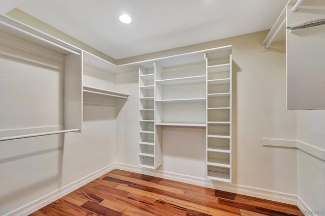 spacious closet featuring hardwood / wood-style flooring