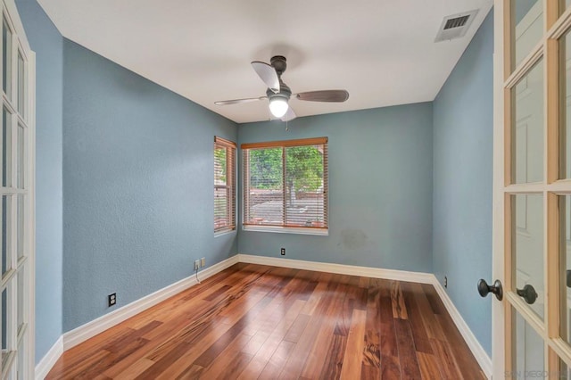 spare room with hardwood / wood-style floors and ceiling fan