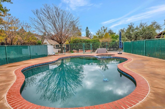 view of pool with an in ground hot tub