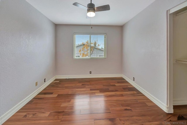 unfurnished dining area featuring dark hardwood / wood-style floors and ceiling fan